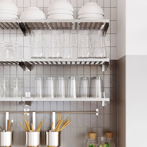 Kitchen featuring a KUNGSFORS shelf with clear glasses and metal containers on a white tiled wall.