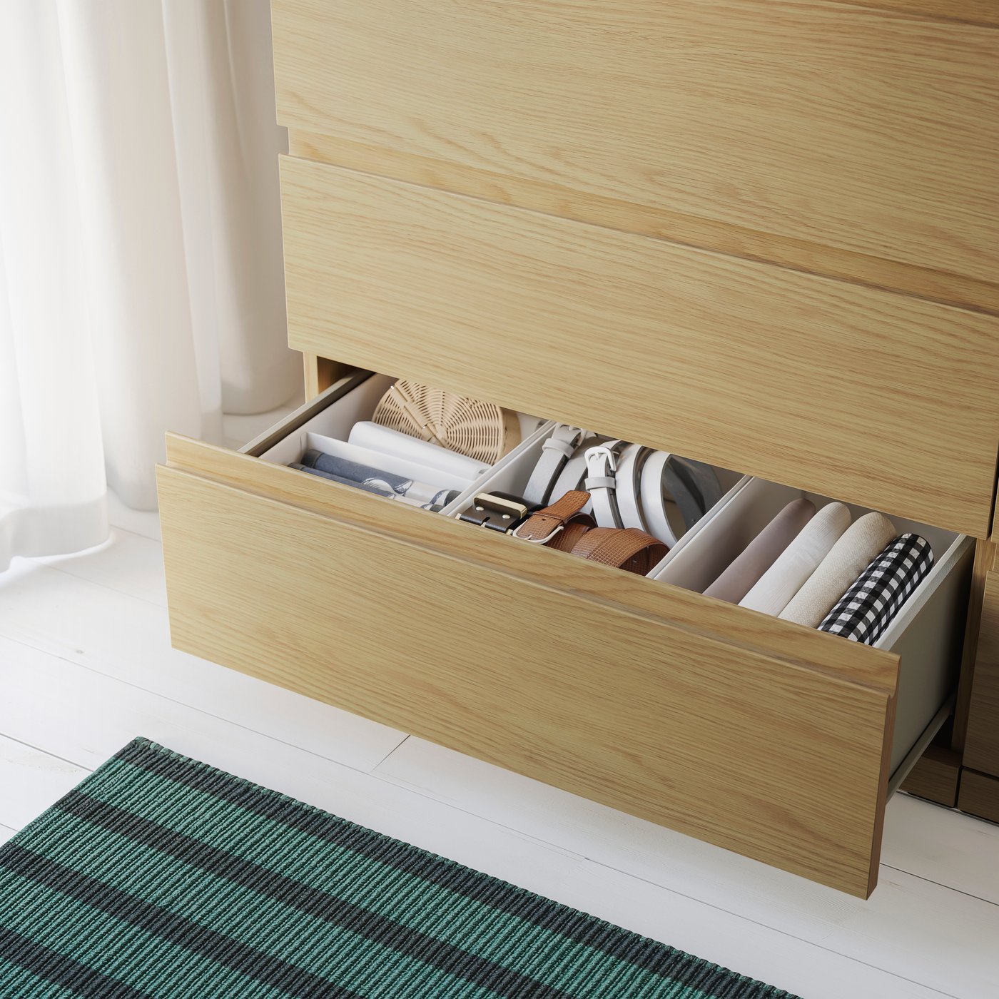 Open drawer of a wood-coloured chest of drawers