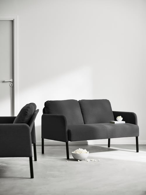 Workspace featuring multiple standard 2 seat sofas with thick seat, padded armrests and soft back cushions.