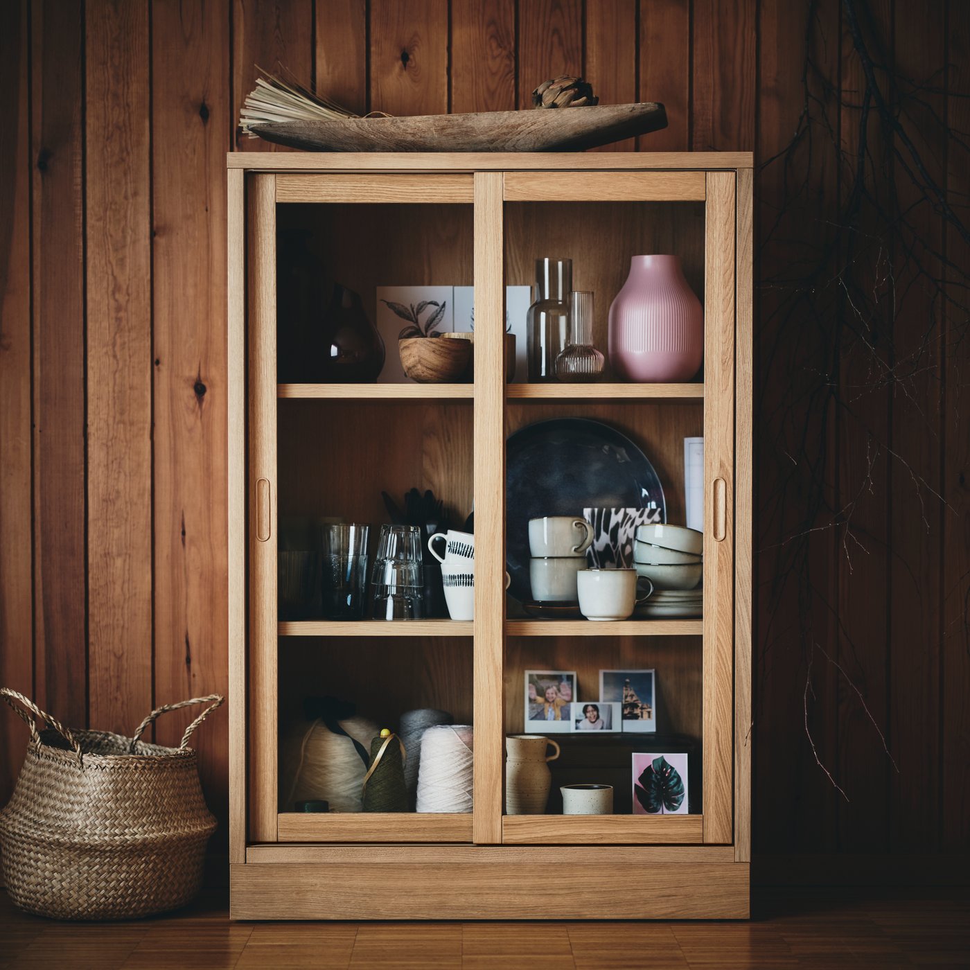 A TONSTAD cabinet in oak veneer with glass sliding doors