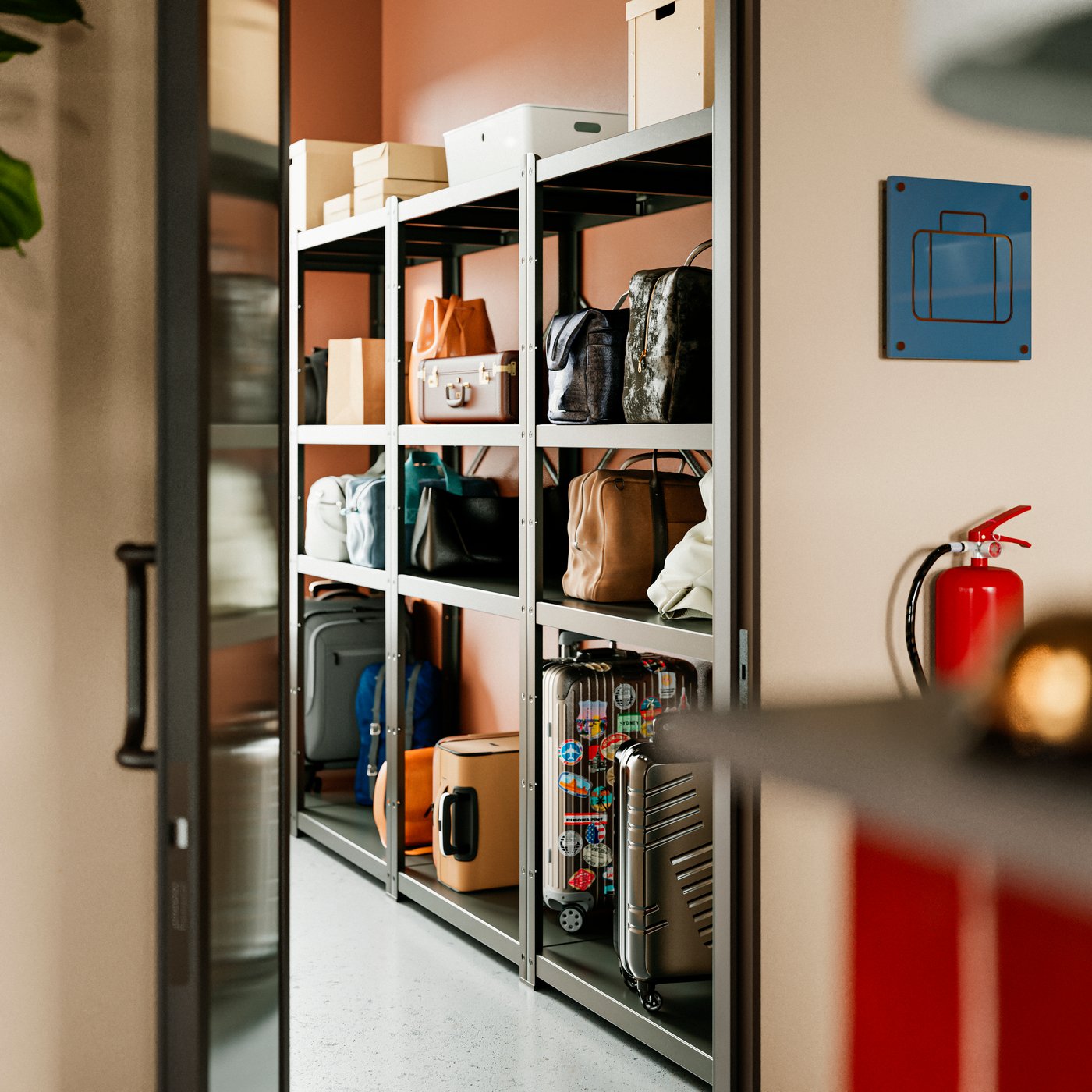 A luggage room featuring black BROR post stands against the wall, holding multiple bags and storage boxes on open shelving.