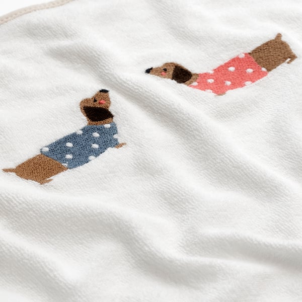 A puppy pattern/white SKÖTSAM cover for babycare mat
