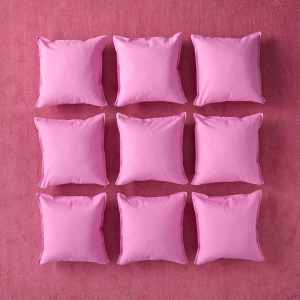 A pink GURLI cushion cover