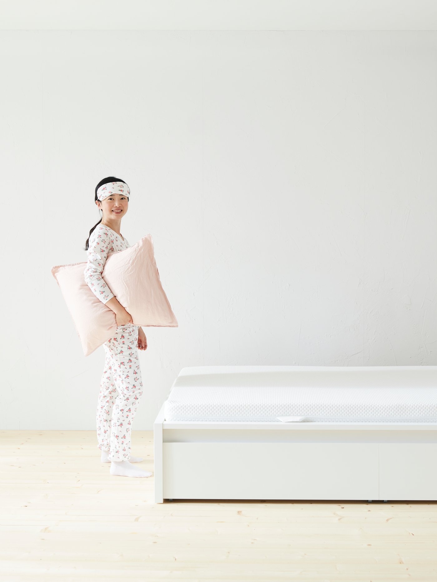A firm/white ÅBYGDA foam mattress in the bedroom