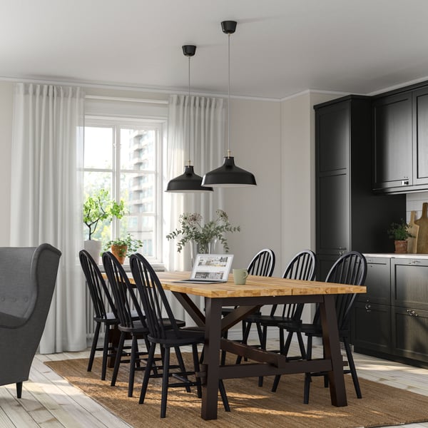 An acacia/black SKOGSTA dining table