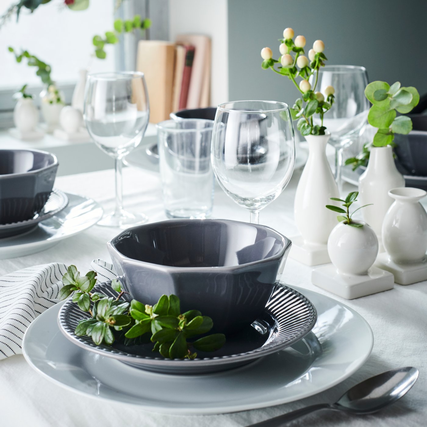 Grey STRIMMIG dinnerware set on white table cloth 