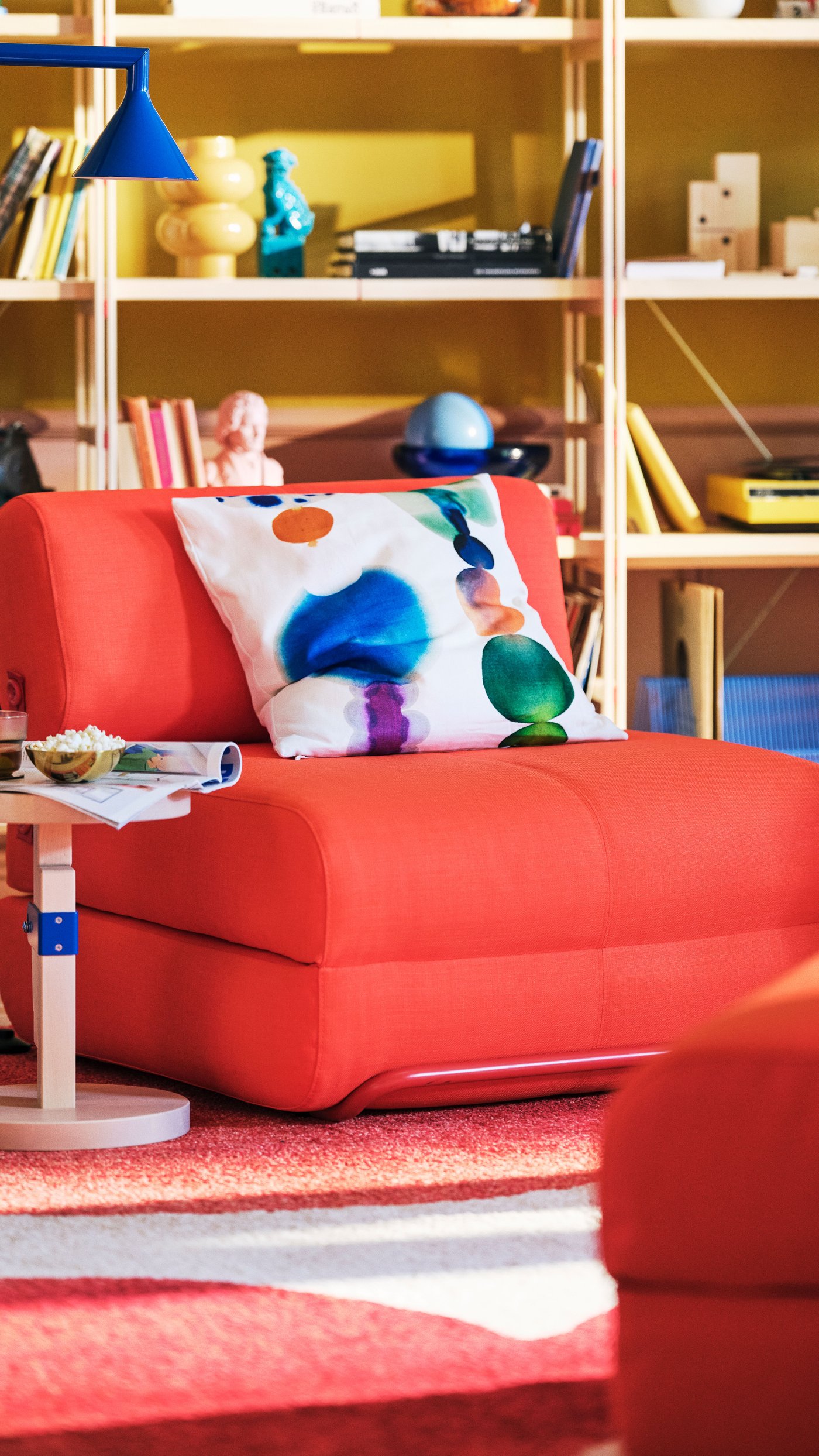 A Skiftebo bright orange IKEA PS 2026 chair-bed in the living room