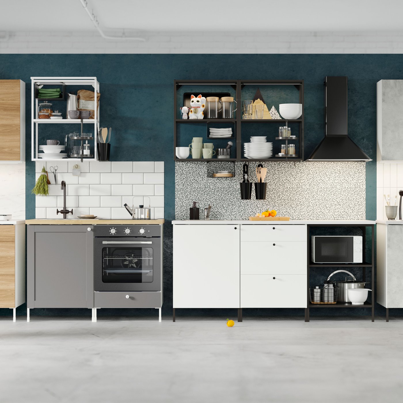 A set up of four different IKEA EHNET kitchens in different styles and finishes all along one wall that has been painted dark blue with a grey floor