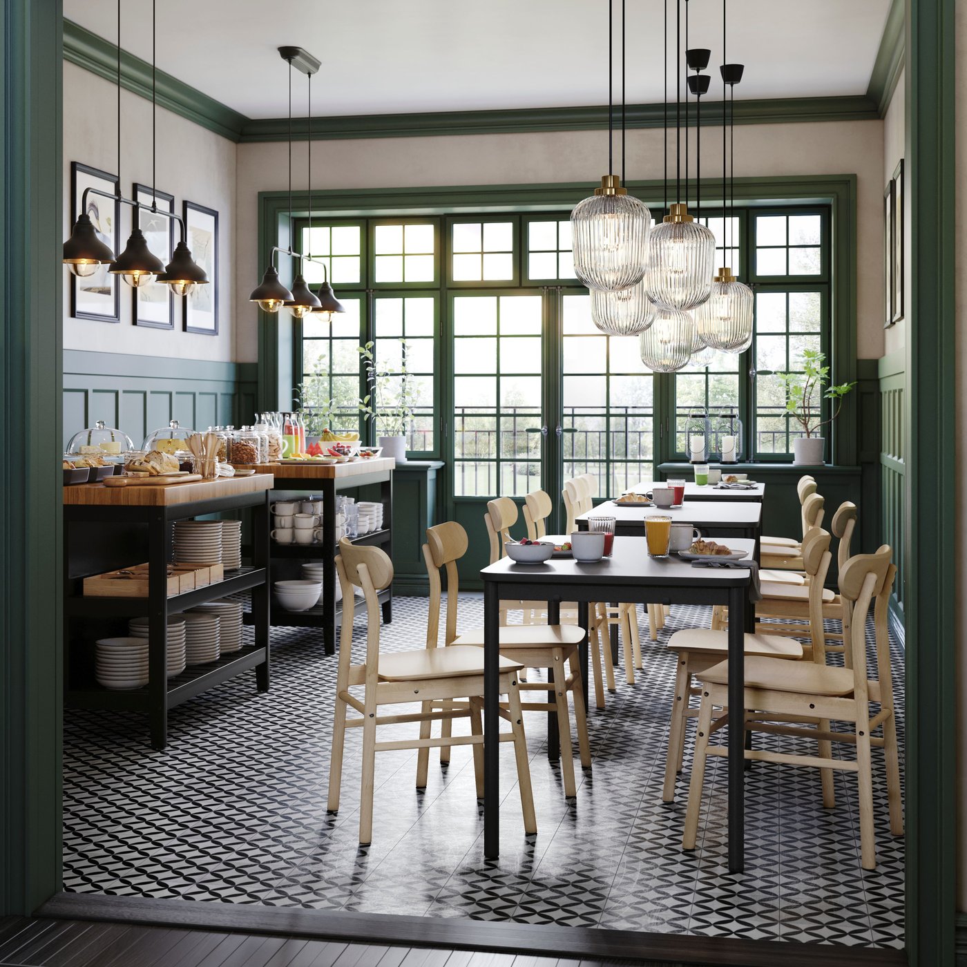 A room in a café with TOMMARYD tables, birch RÖNNINGE chairs and two VADHOLMA kitchen islands holding food and dinnerware.