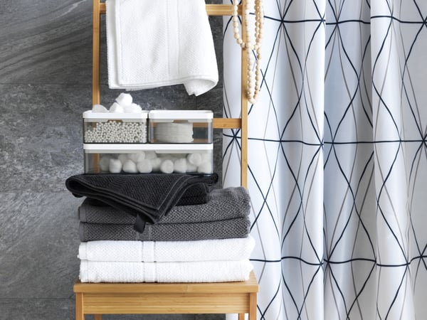 A black FRÄJEN hand towel