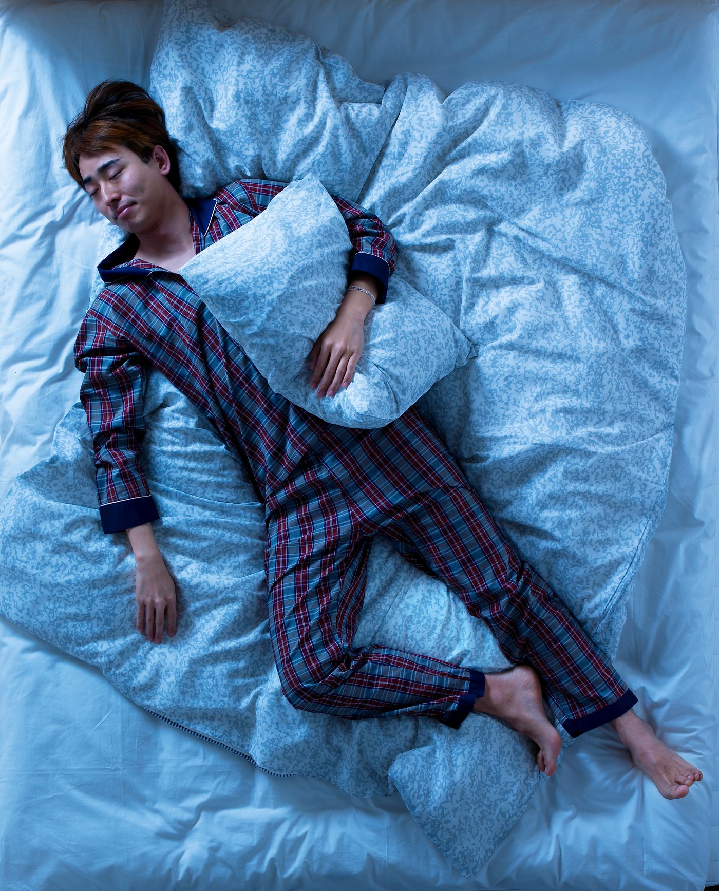 un homme qui dort dans son lit