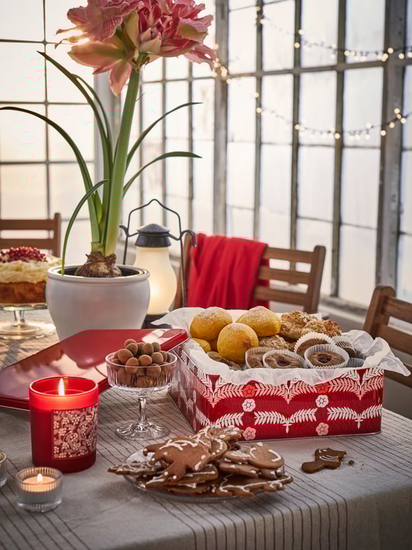 Red and white Swedish Christmas themed fika / afternoon tea with cakes, ginger thins and VINTERFINT candle and tin.