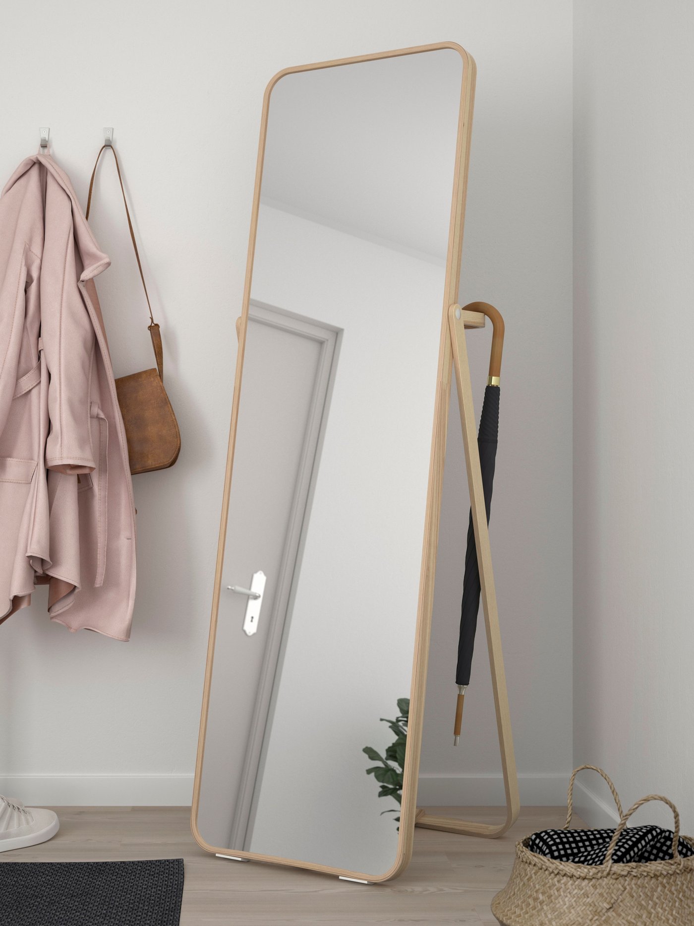 An ash IKORNNES standing mirror