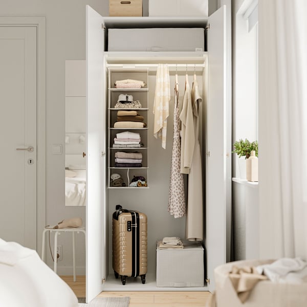 A white LASTARE wardrobe combination in the bedroom.