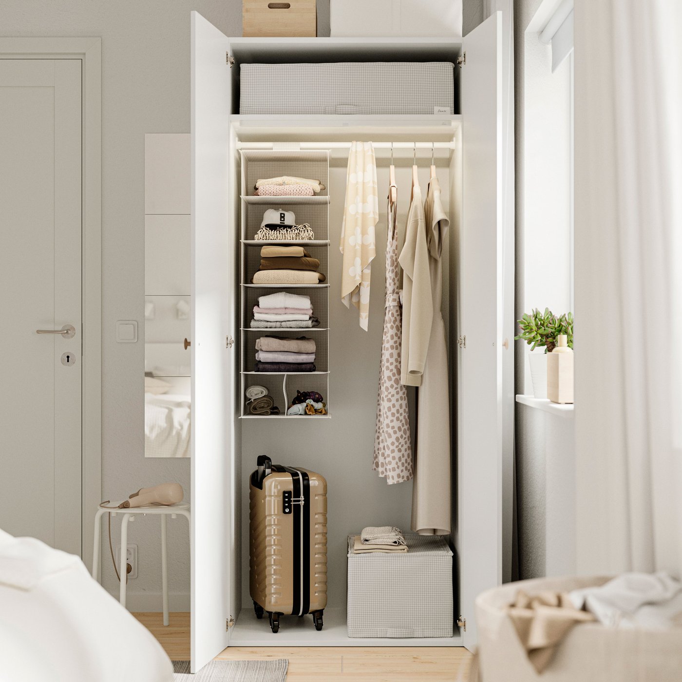 A white LASTARE wardrobe combination in the bedroom