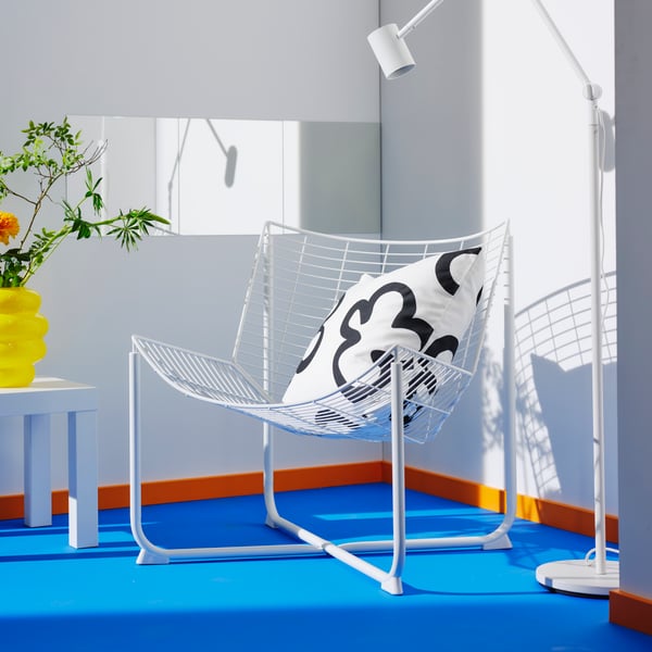 A white/black KLIPPBRÄCKA cushion cover