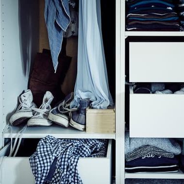 Das Innenleben eines Kleiderschranks mit Regalböden, Schubladen und Platz für hängende Kleidung.