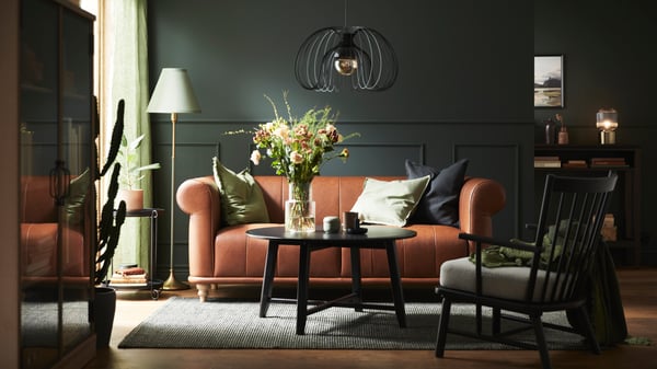 A living room furnished with a sofa, table, and armchair.