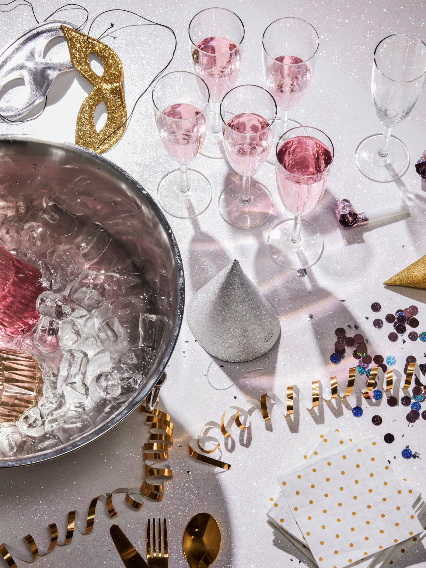 Ein klares SVALKA Sektglas steht auf einem weißen Tisch mit Deko.