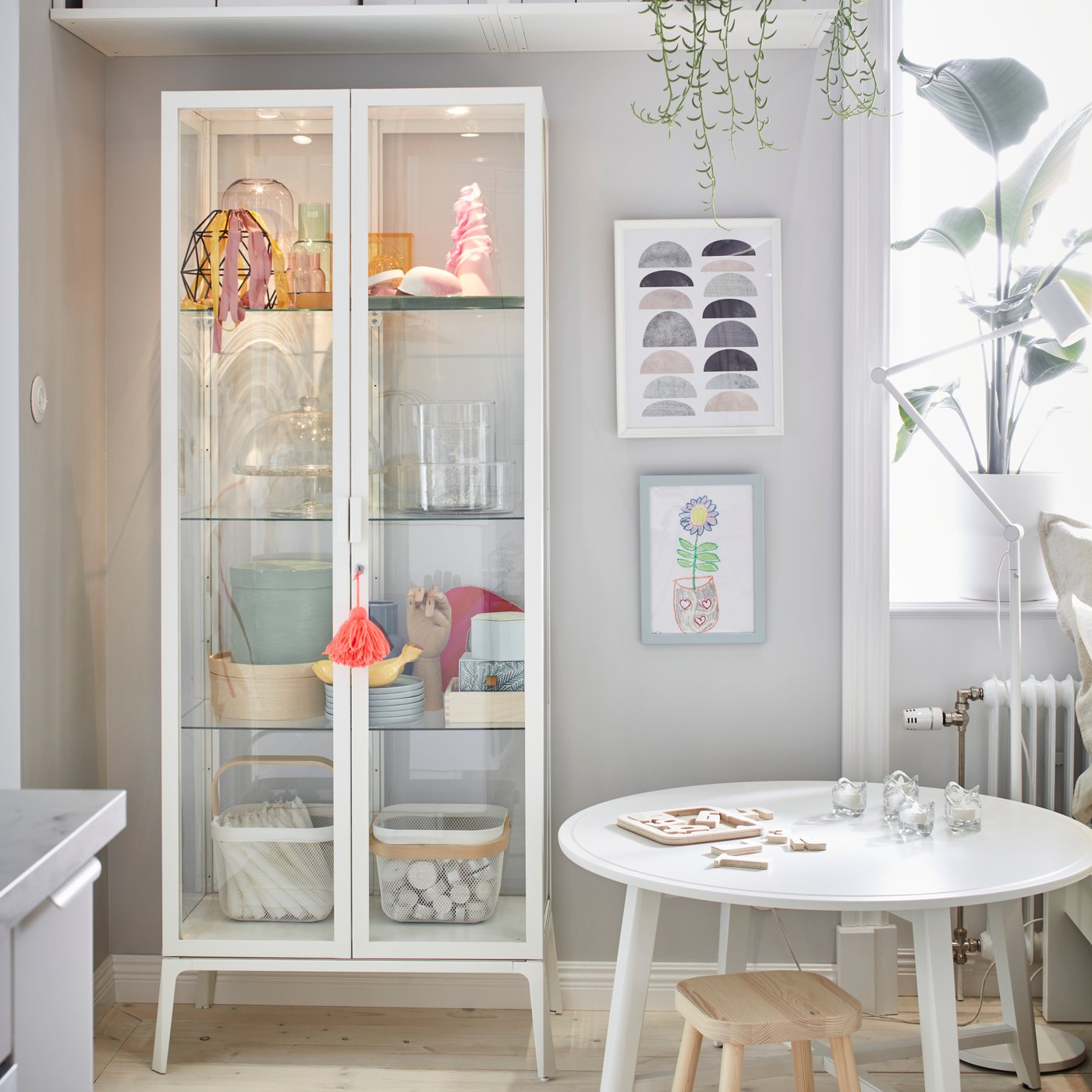 A white MILSBO glass-door cabinet in the living room