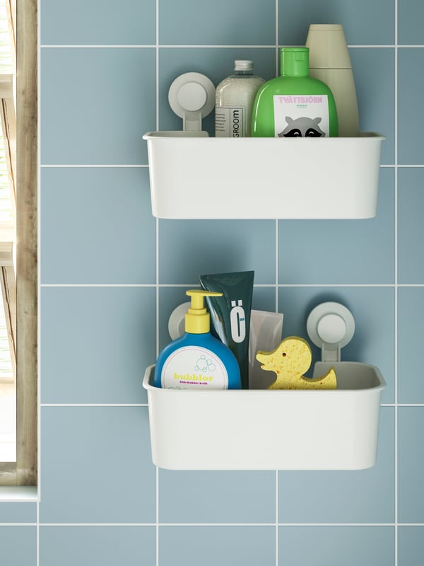 A white TISKEN basket with suction cup in the bathroom