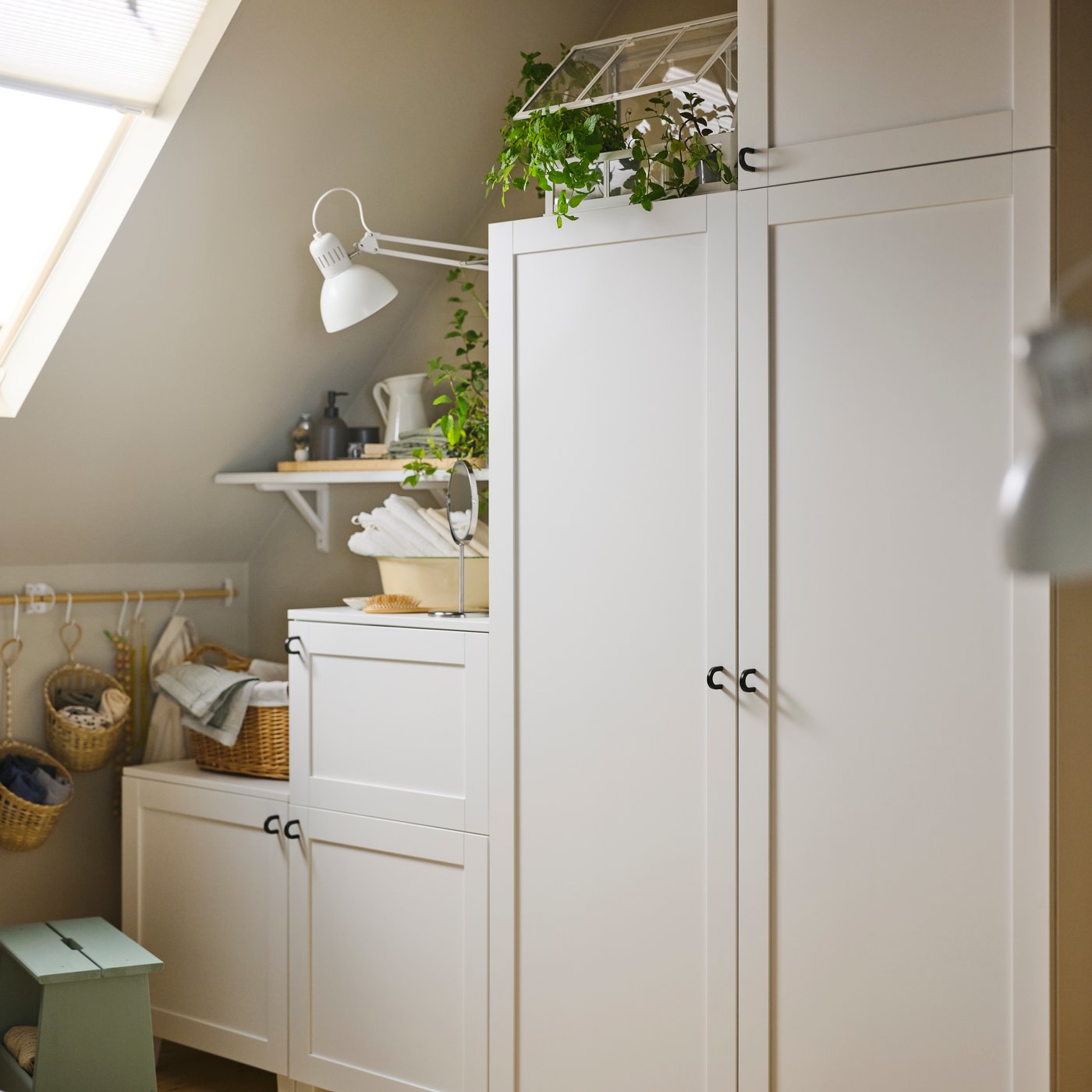 A PLATSA system, placed in a space with a slanted ceiling, with potted plants and accessories placed on top of it.