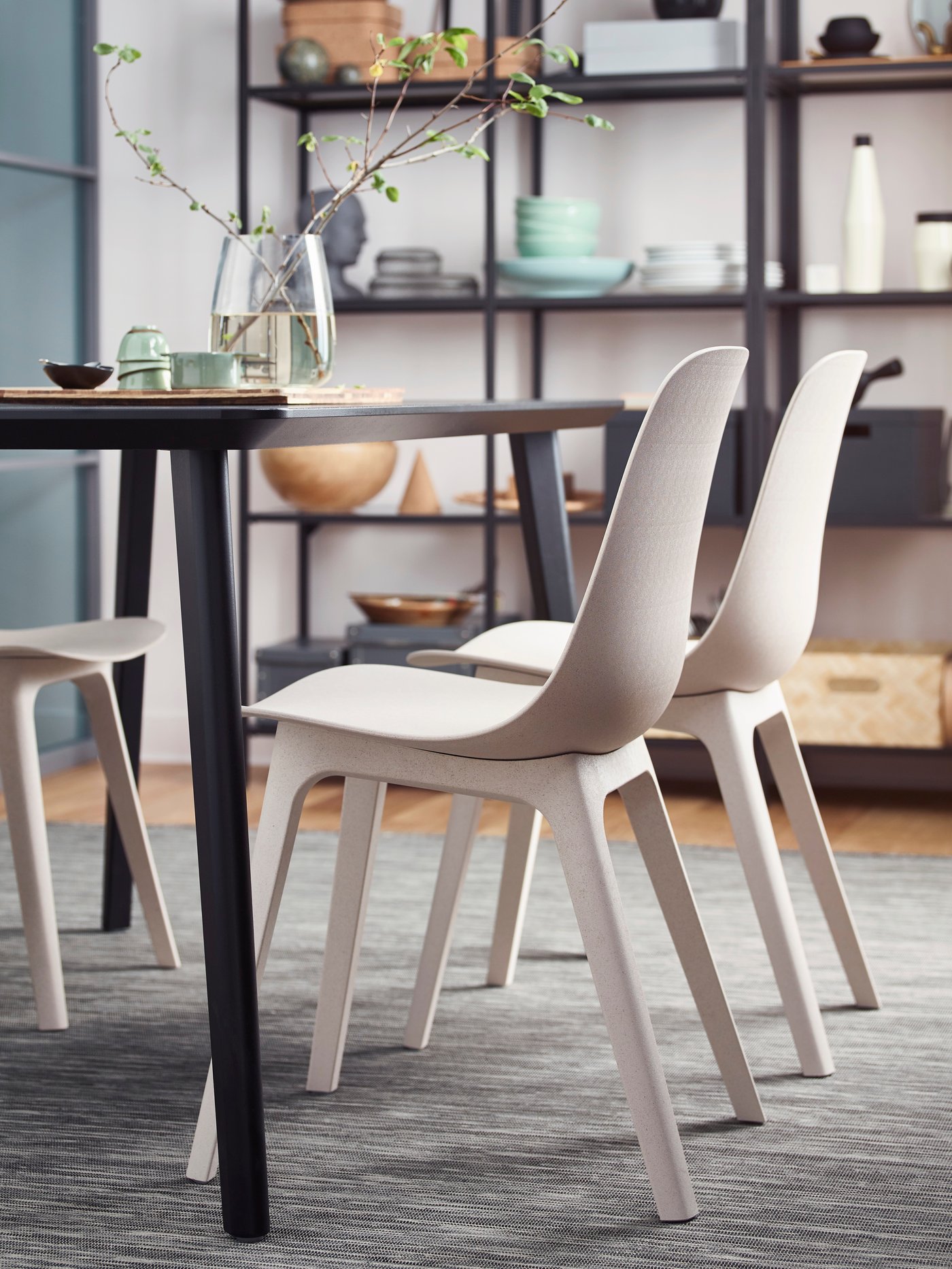 A grey/black HODDE rug flatwoven, in/outdoor in the dining room