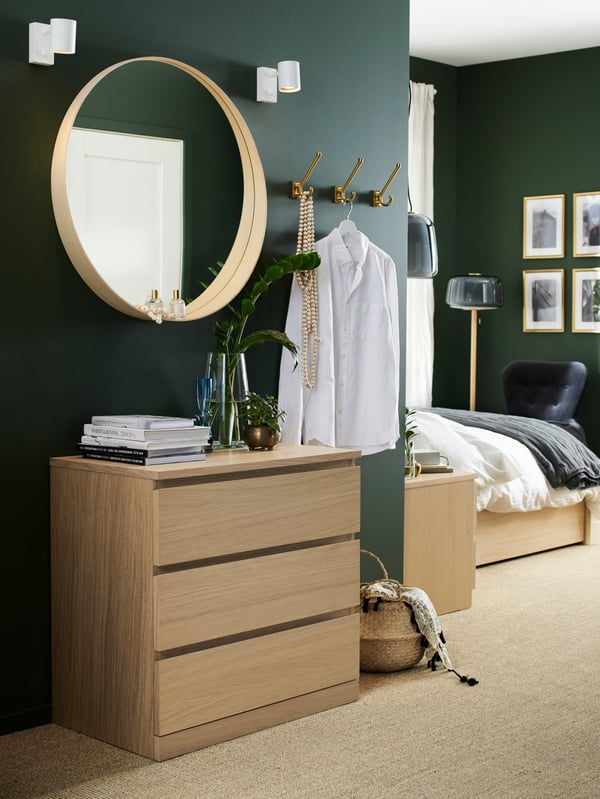A brass-colour KÄMPIG hook in the bedroom