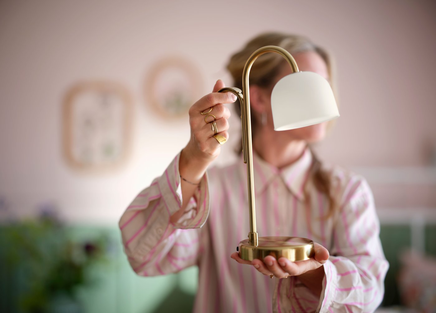 A battery-operated brass/opal white glass TVÅMASTAD LED portable lamp