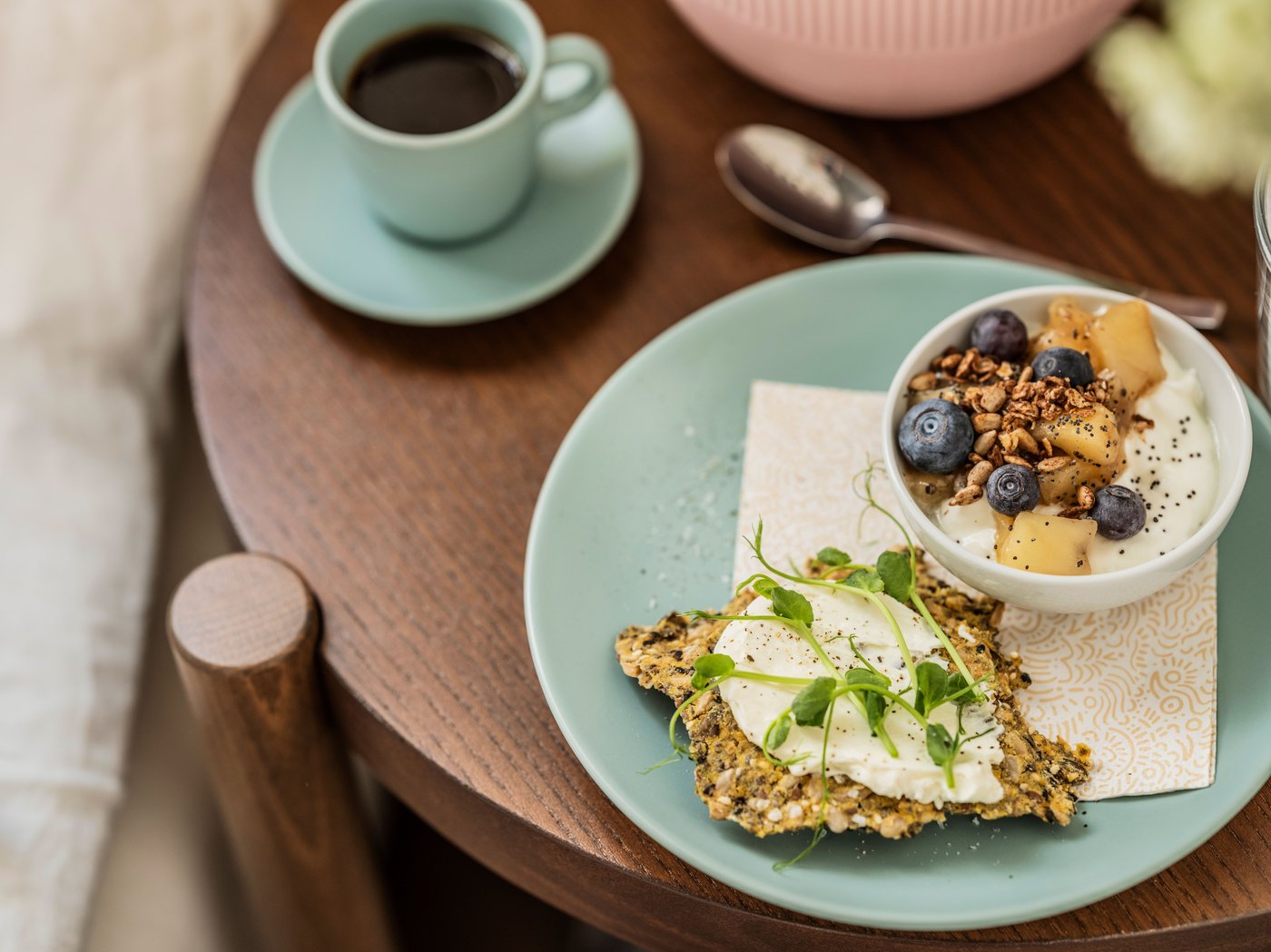 A matt/light turquoise FÄRGKLAR cup with saucer