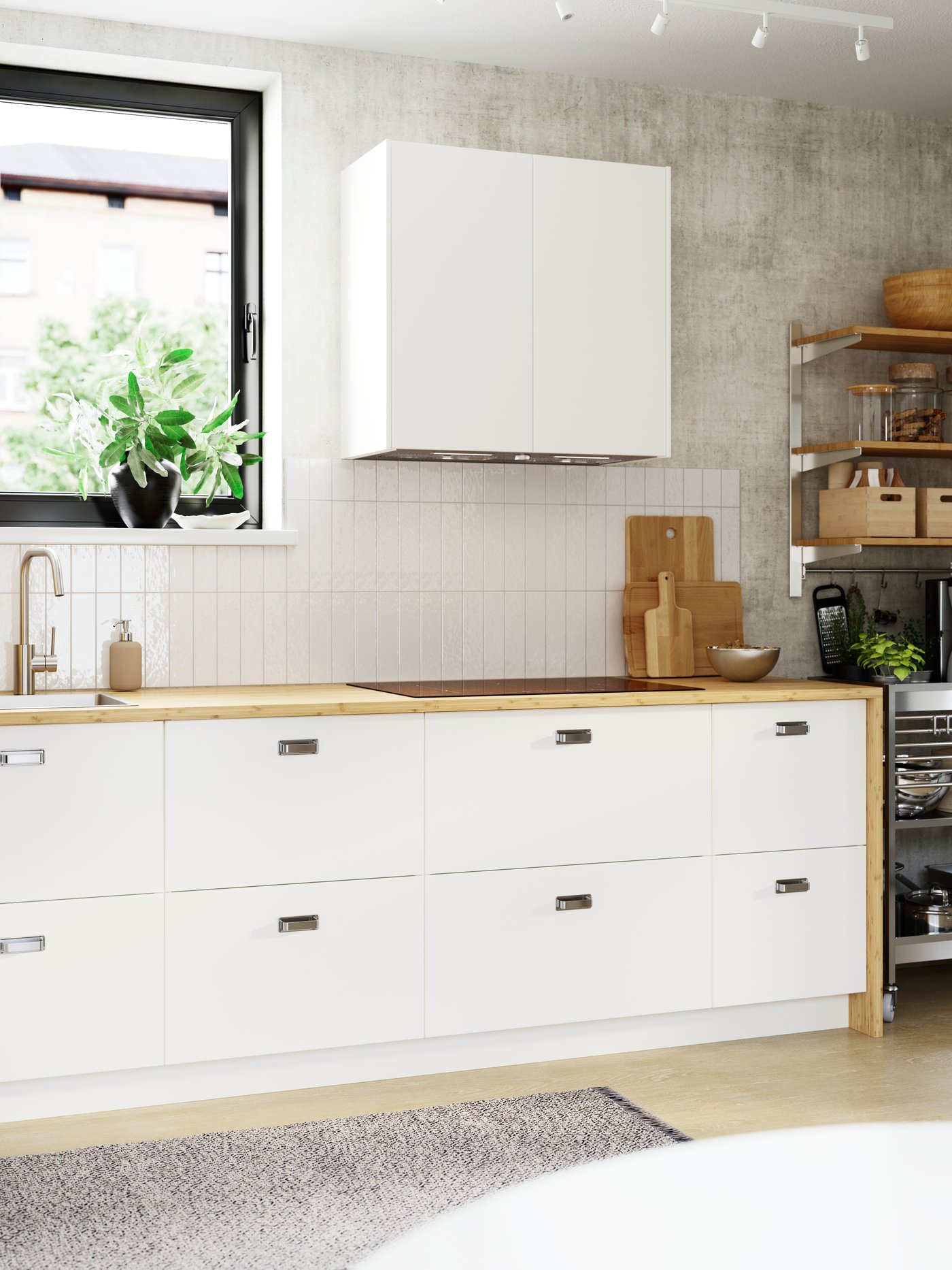 A bright, white-tiled kitchen wall has two high cabinets and eight spacious drawers with smooth, white VEDDINGE fronts.