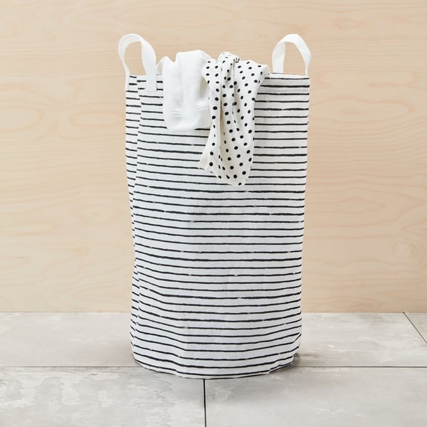 A white/black KLUNKA laundry bag in the bathroom