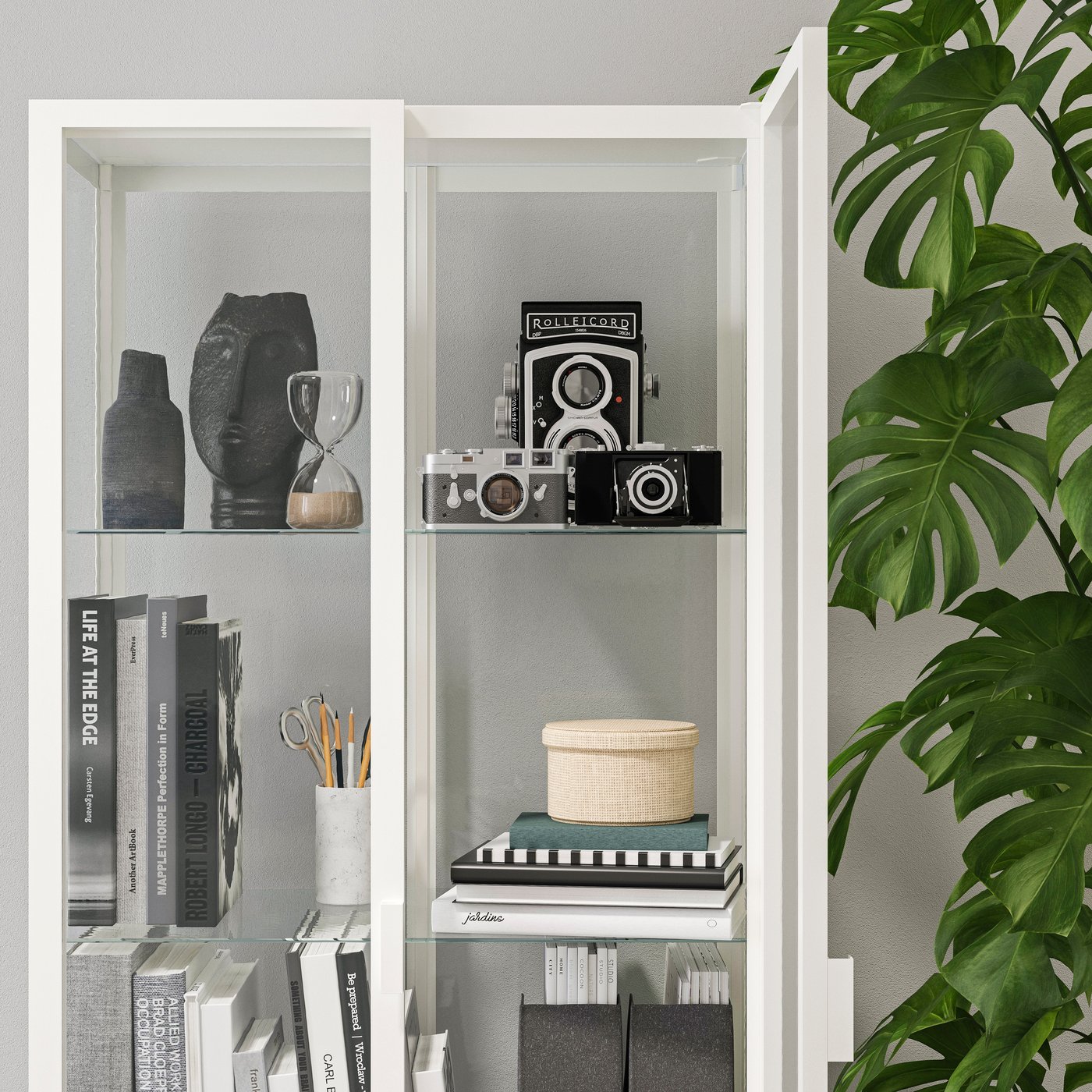 A white MILSBO glass-door cabinet in the living room
