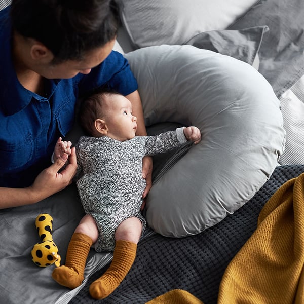 A dad is holding his baby in his arms.