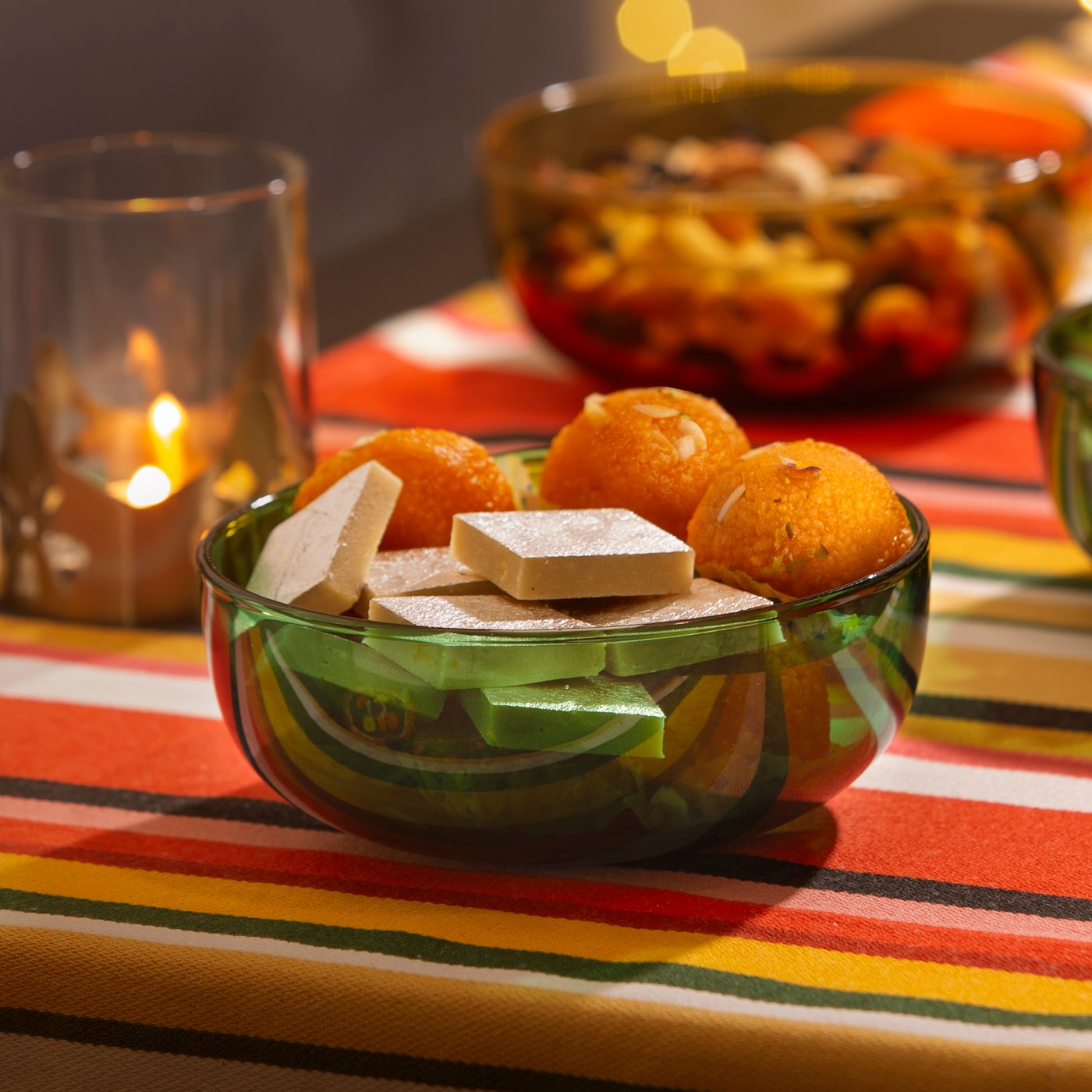 A glass/green AROMATISK serving bowl