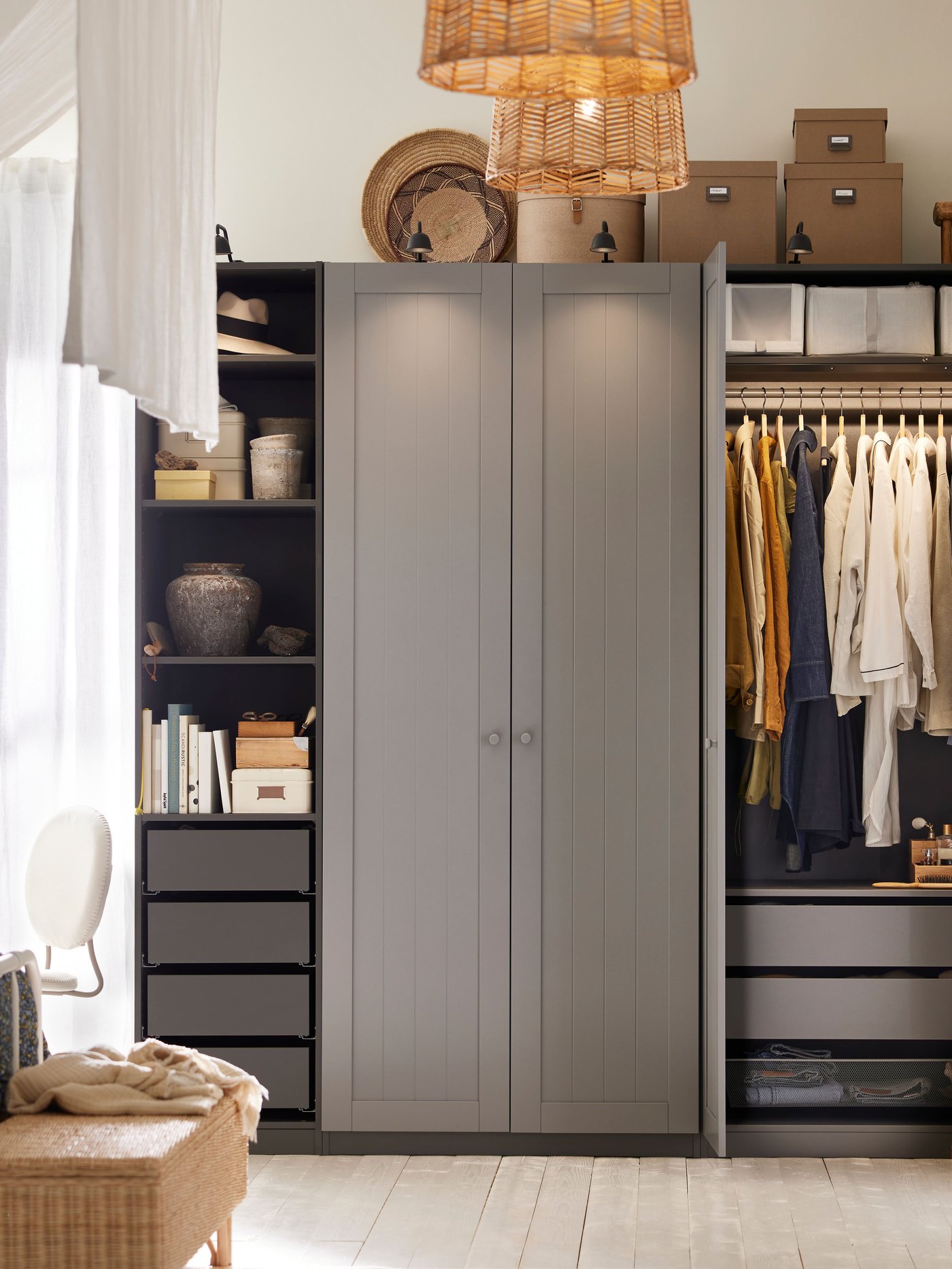A dark grey/grey PAX/GULLABERG wardrobe combination has two doors open showing clothes on a rail and shoe boxes on a shelf.