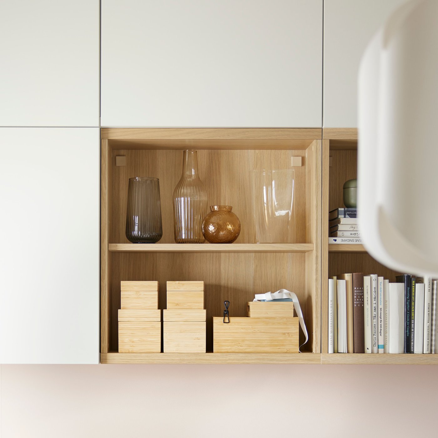 Six white stained oak effect BESTÅ frames, with four having white LAPPVIKEN doors. Two are open showing items on shelves.