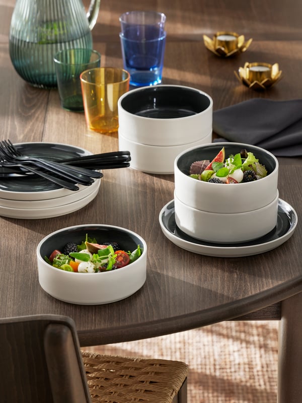 PAPPERSBJÖRK glasses, tealight holders and OMBONAD bowls and plates stand on a SKANSNÄS round extendable table.