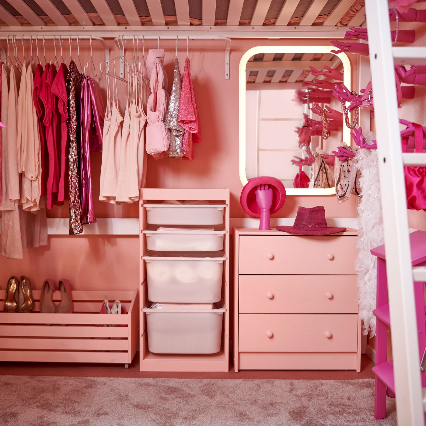 A view of a storage under a loft bed  from the front. All furniture, clothes and accessories are in different shadses of pink..