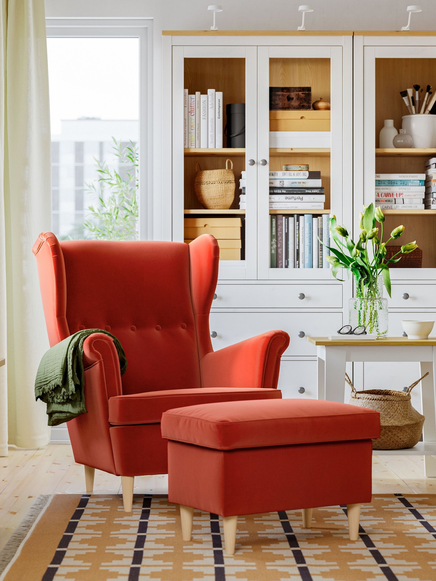 A Tommaboda brown-red STRANDMON wing chair with footstool in the living room