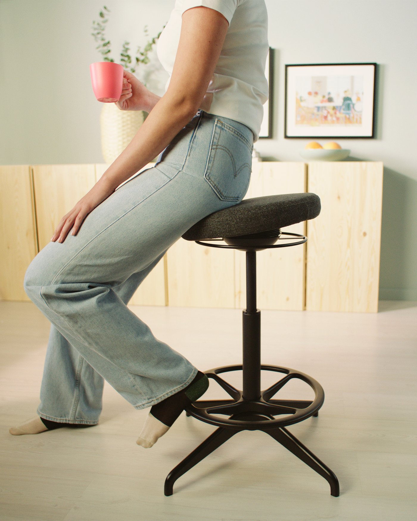 A Gunnared dark grey LIDKULLEN active sit/stand support in the home office