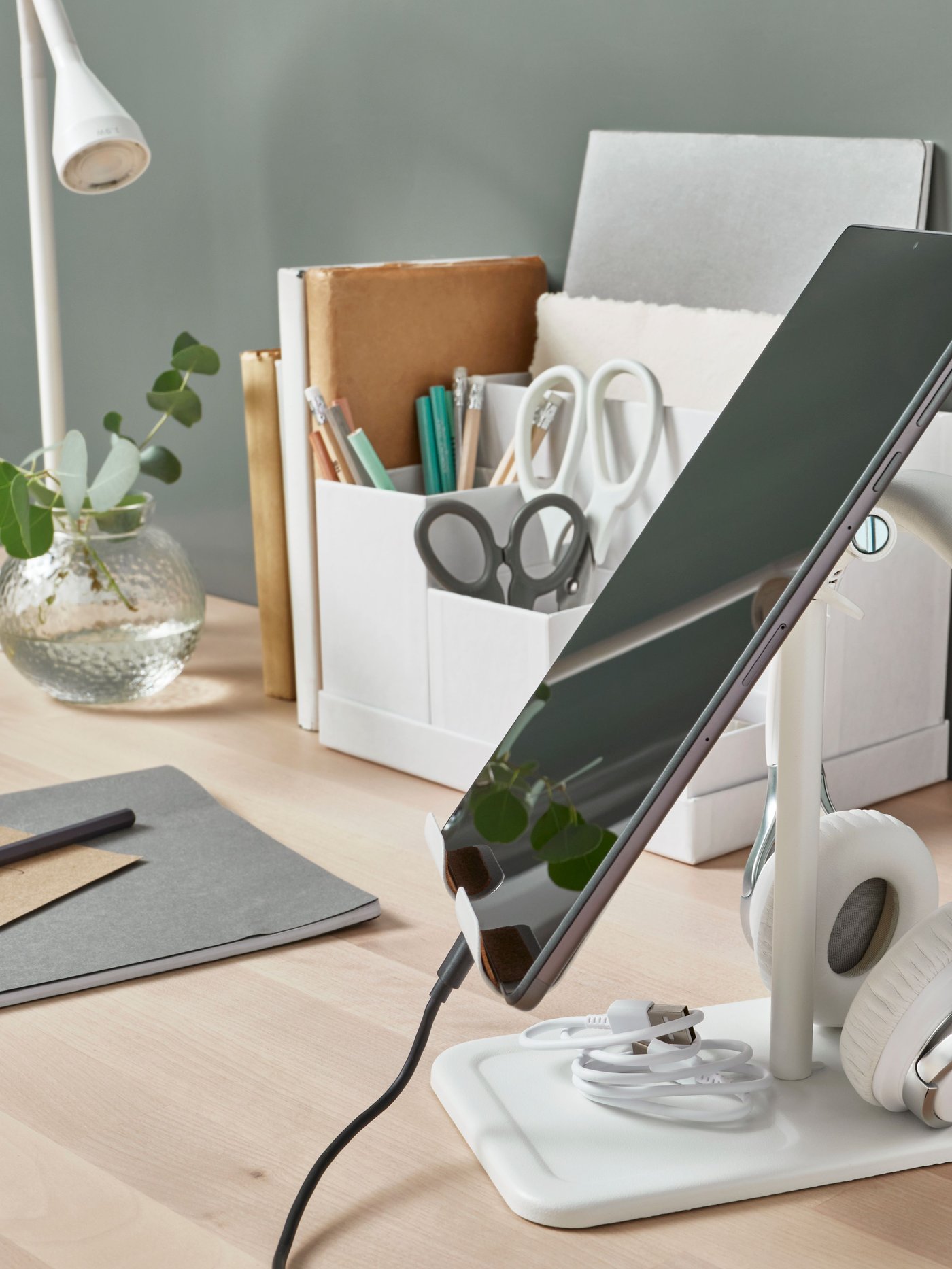 A tablet holded by a BERGENES holder for mobile or tablet in bamboo.