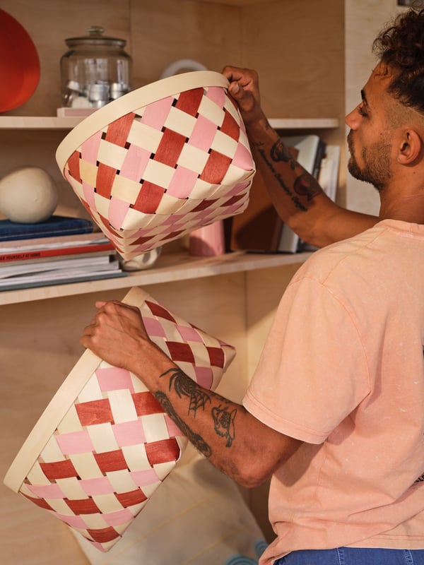 An orange/pink OMMJÄNGE basket in the home office