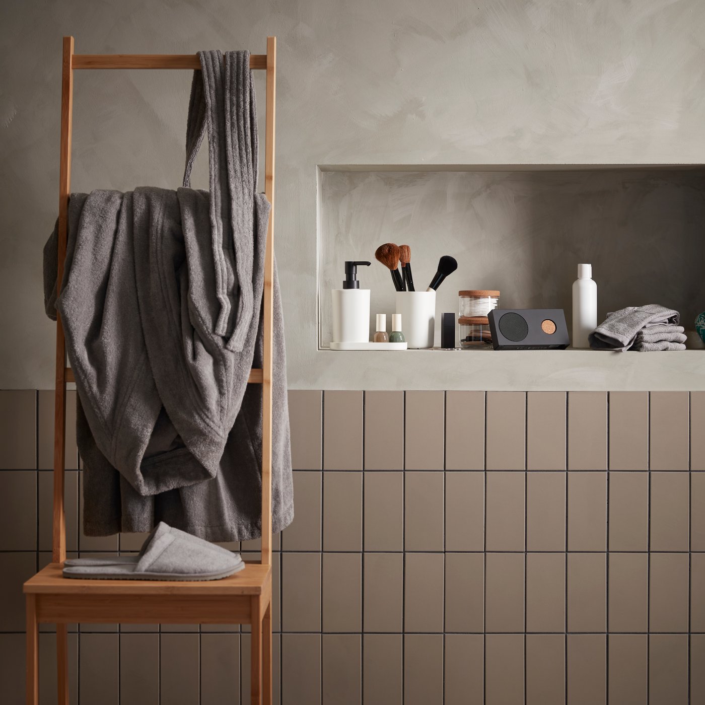 A grey TÅSJÖN slippers in the bathroom