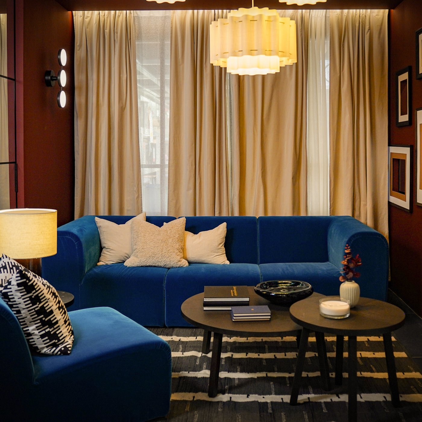 Curious Library room setting at IKEA Tampines, featuring a Alhamn dark turquoise STOCKHOLM 2025 3-seat sofa, STOCKHOLM 2025 Side table, and STOCKHOLM 2025 coffee table.