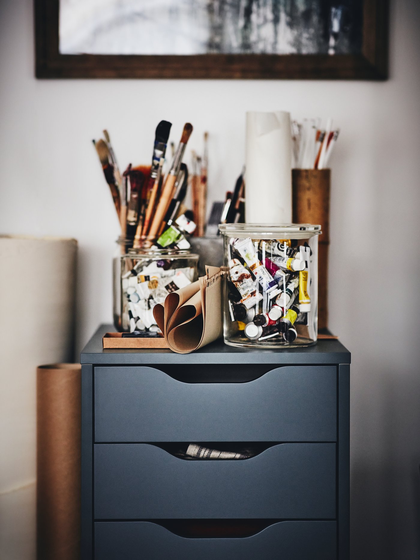 Close-up on ALEX drawer unit in grey-turquoise with art supplies on top of it.