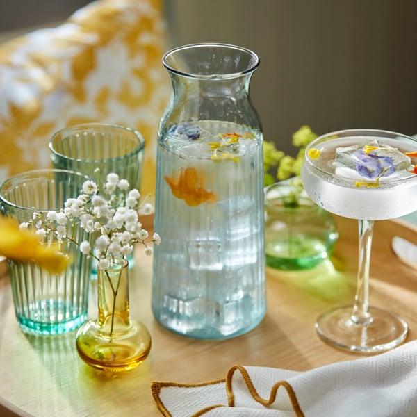 An yellow/white FJUNKLOCKA cushion cover