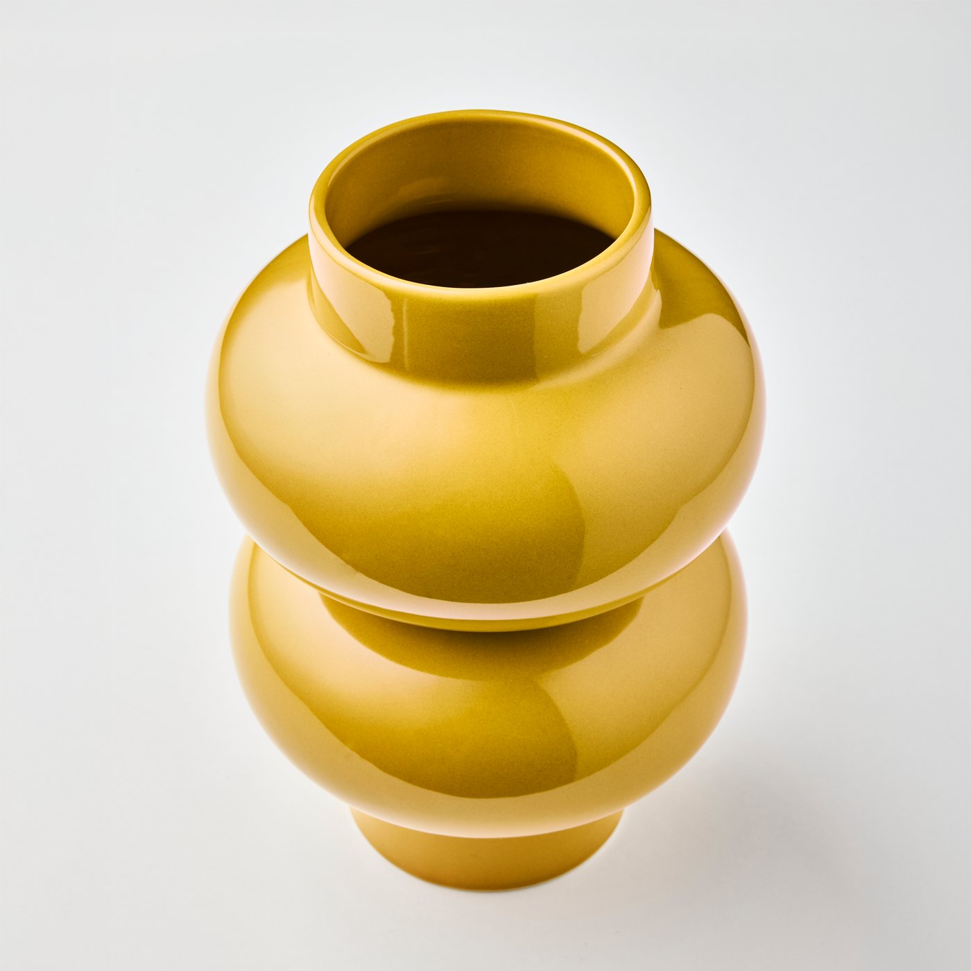 مزهرية PÄRLHÄGG بلون أصفر-بيج فريدة فارغة، تظهر بزاوية تبرز تصميمها المنتفخ ومظهرها الخارجي اللامع والعاكس للضوء.