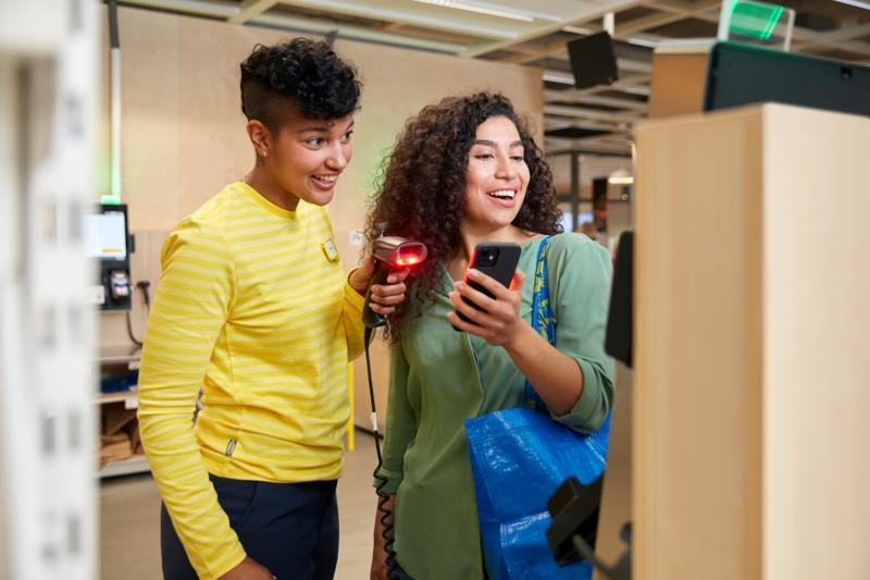 A customer purchasing IKEA products at checkouts