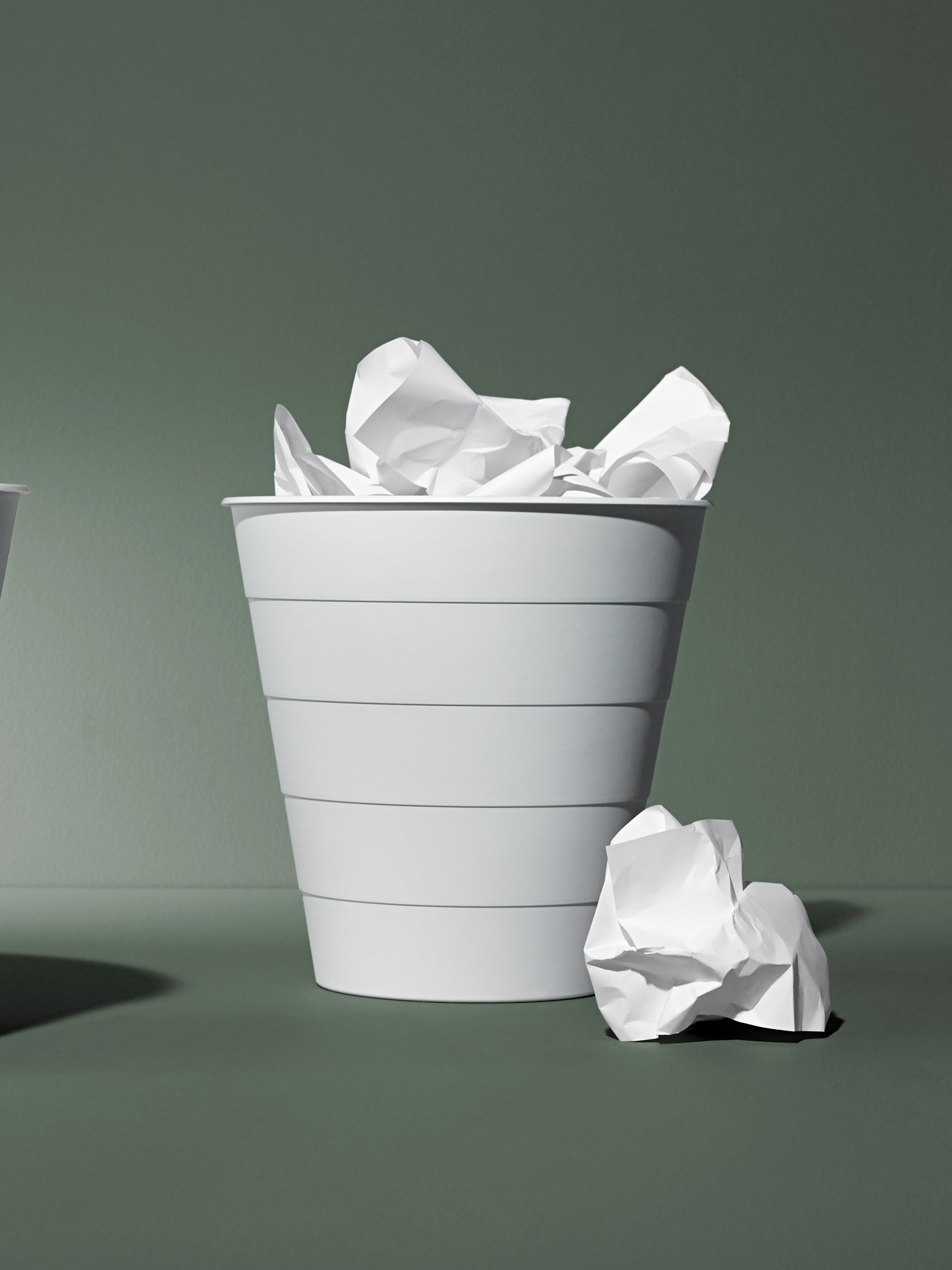 A white FNISS waste bin